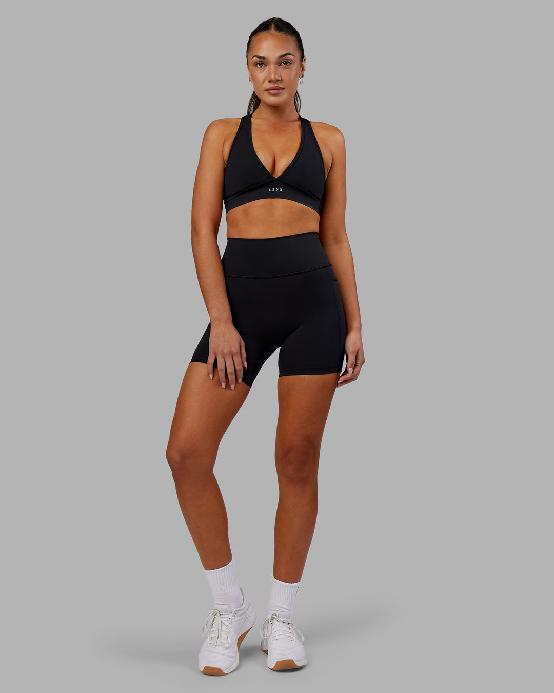 Woman wearing Fusion Ultra High-Rise 6&quot; Short Pockets - Black | Model:Kirstyn | Size:S
