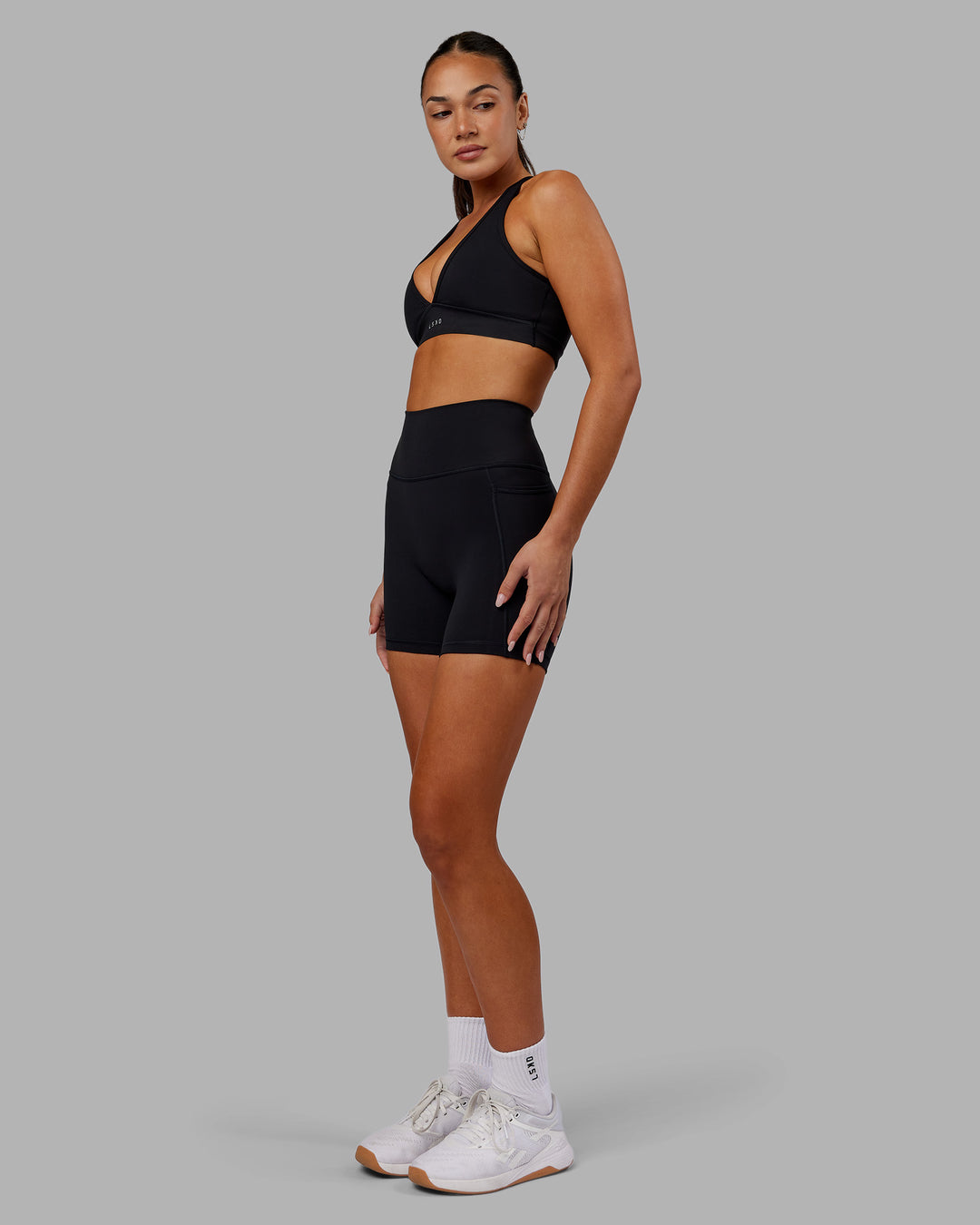 Woman wearing Fusion Ultra High-Rise 6&quot; Short Pockets - Black | Model:Kirstyn | Size:S