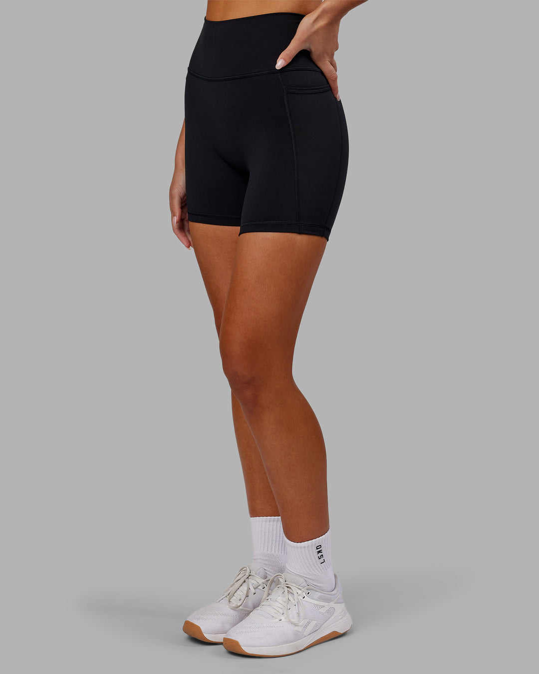 Woman wearing Fusion Ultra High-Rise 6&quot; Short Pockets - Black | Model:Kirstyn | Size:S