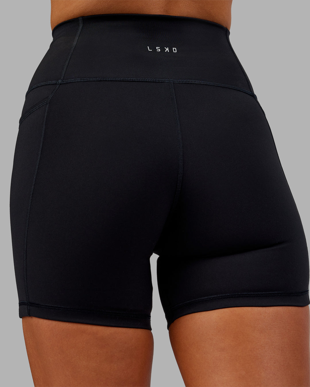 Woman wearing Fusion Ultra High-Rise 6&quot; Short Pockets - Black | Model:Kirstyn | Size:S