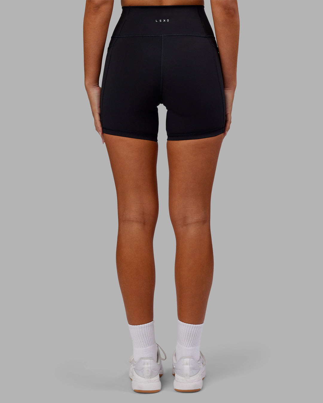 Woman wearing Fusion Ultra High-Rise 6&quot; Short Pockets - Black | Model:Kirstyn | Size:S