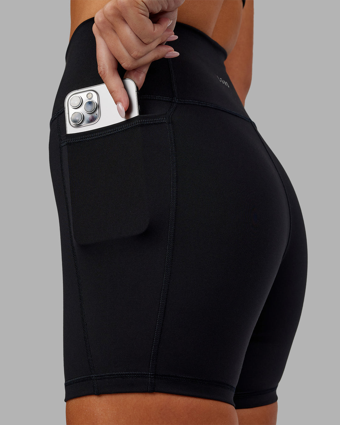 Woman wearing Fusion Ultra High-Rise 6&quot; Short Pockets - Black | Model:Kirstyn | Size:S