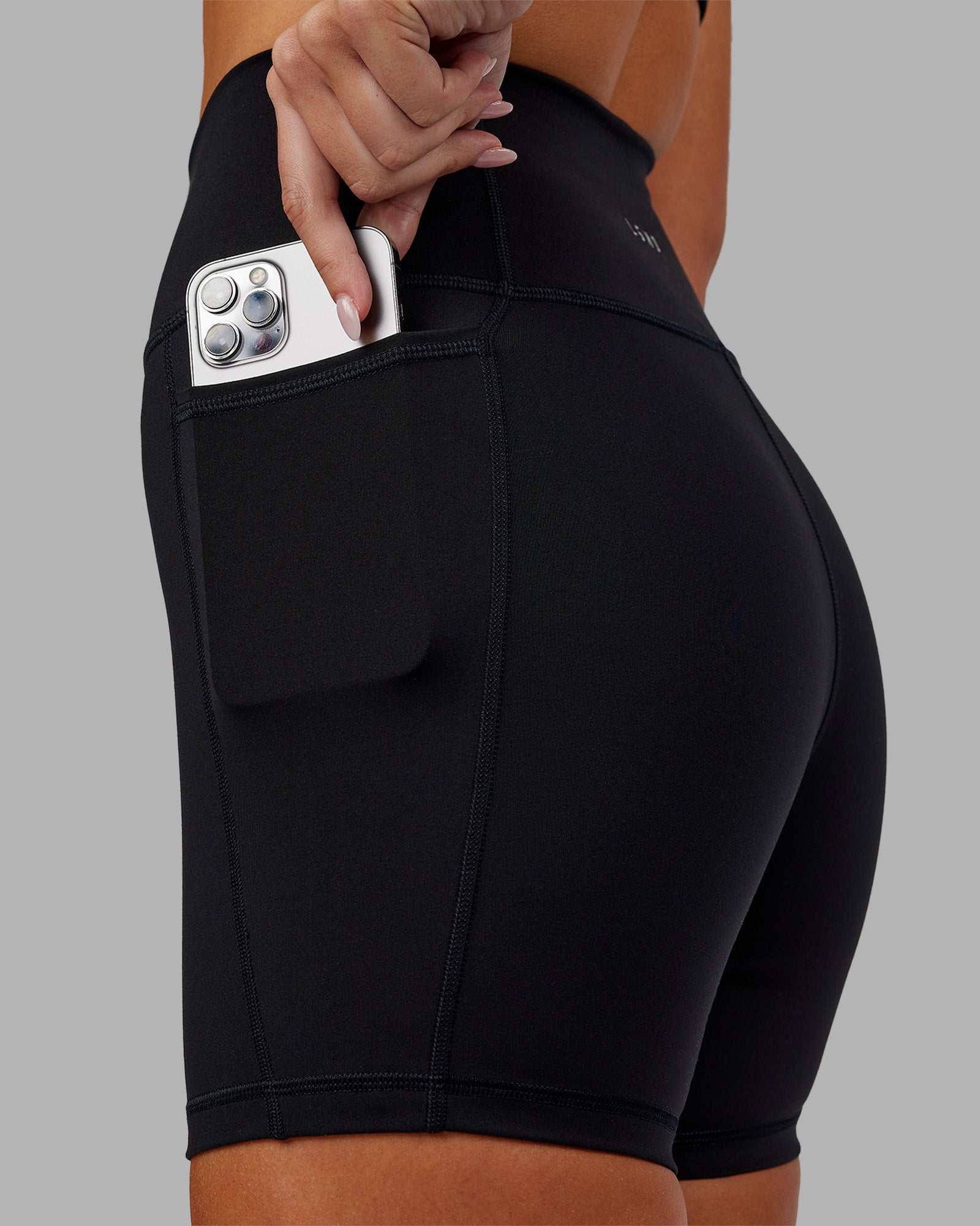 Woman wearing Fusion Ultra High-Rise 6" Short Pockets - Black | Model:Kirstyn | Size:S