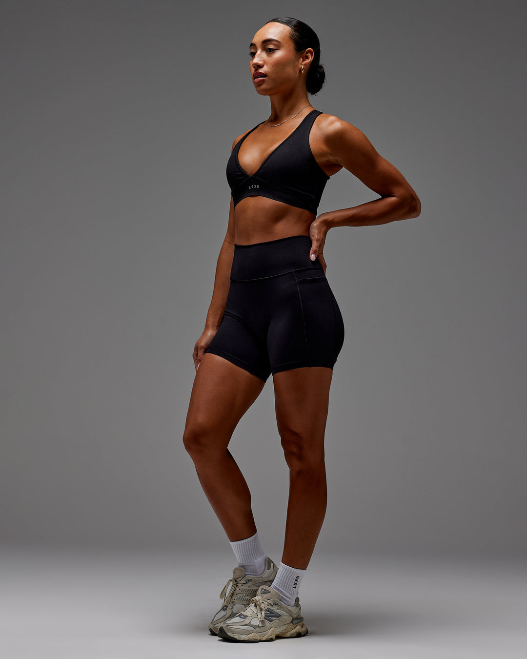 Woman wearing Fusion Ultra High-Rise 6&quot; Short Pockets - Black | Model:Demi | Size:S