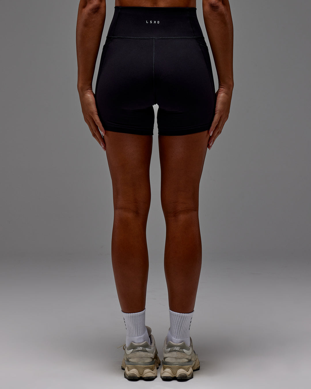 Woman wearing Fusion Ultra High-Rise 6&quot; Short Pockets - Black | Model:Demi | Size:S