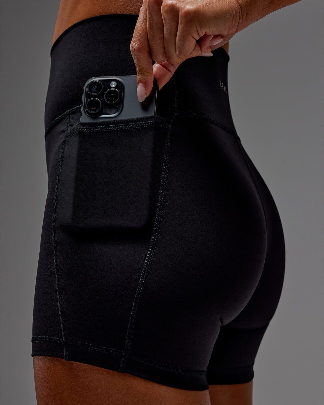 Woman wearing Fusion Ultra High-Rise 6&quot; Short Pockets - Black | Model:Demi | Size:S