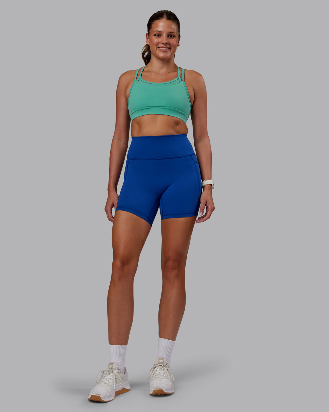 Woman wearing Fusion Ultra High-Rise 6&quot; Short Pockets - Blue Quartz | Model:Phoebe | Size:S
