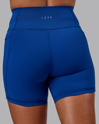 Woman wearing Fusion Ultra High-Rise 6" Short Pockets - Blue Quartz | Model:Phoebe | Size:S
