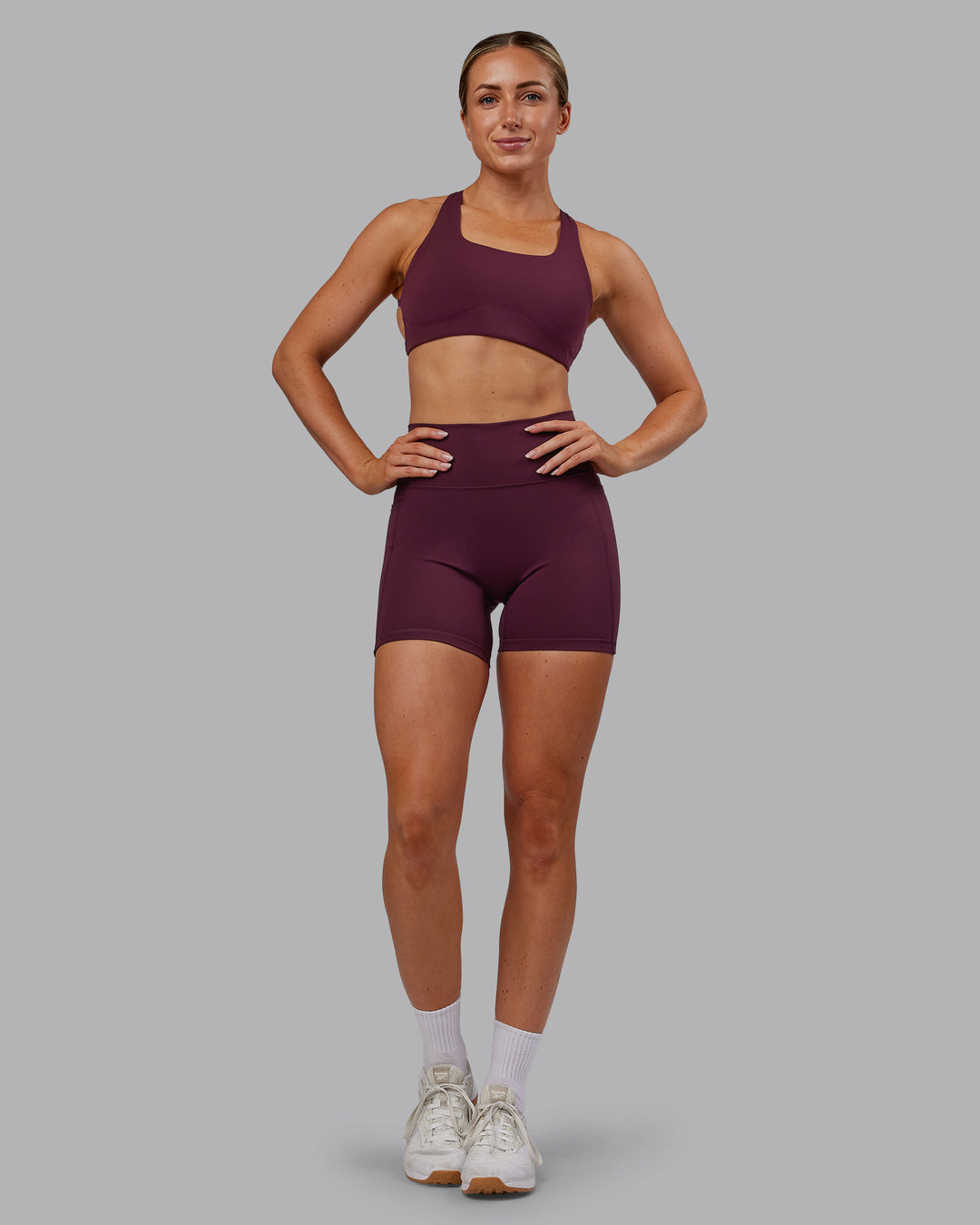 Woman wearing Fusion Ultra High-Rise 6" Short Pockets - Cherry Lacquer | Model:Paris | Size:S