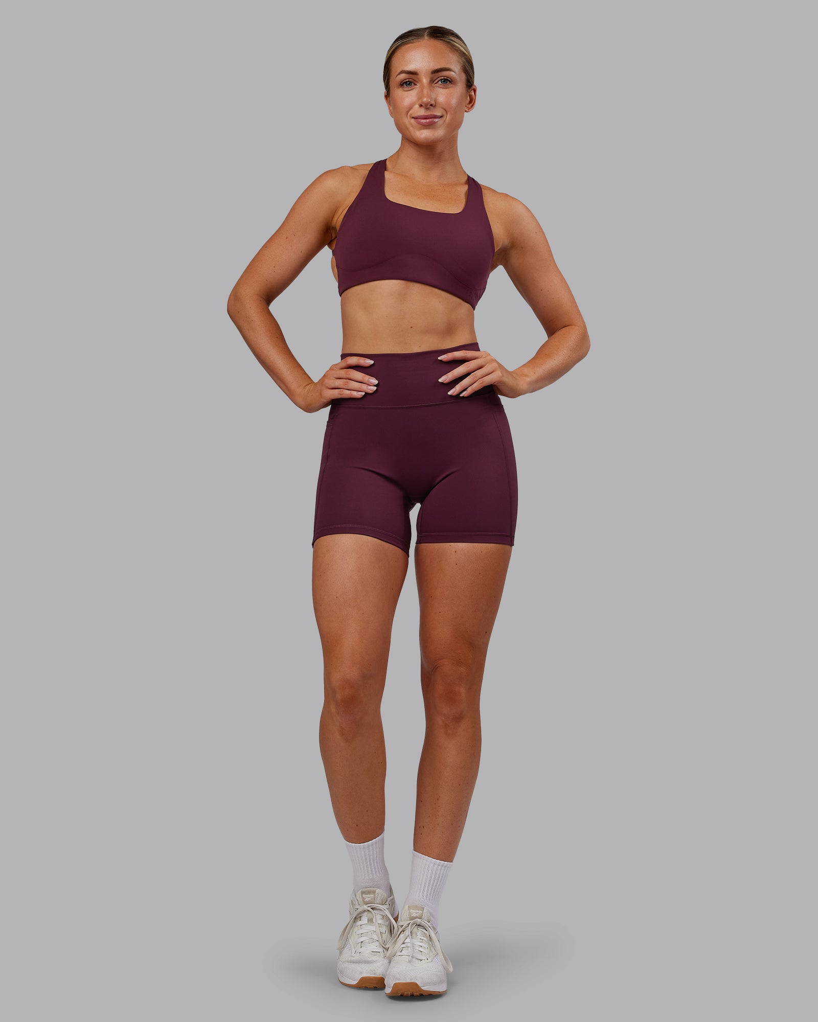Woman wearing Fusion Ultra High-Rise 6" Short Pockets - Cherry Lacquer | Model:Paris | Size:S