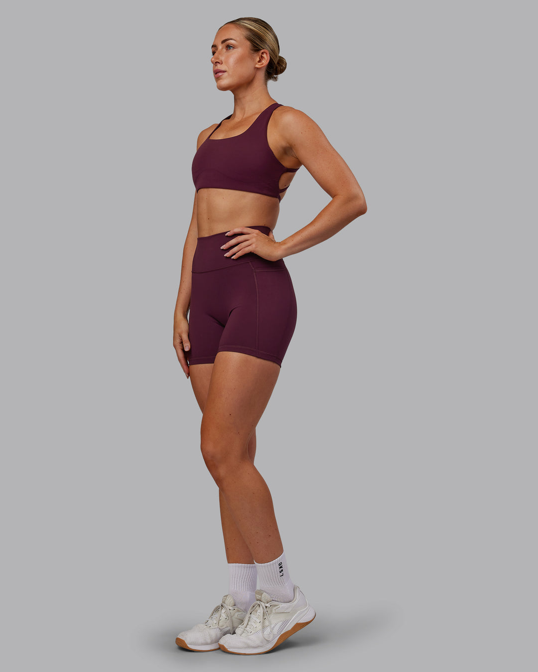 Woman wearing Fusion Ultra High-Rise 6&quot; Short Pockets - Cherry Lacquer | Model:Paris | Size:S