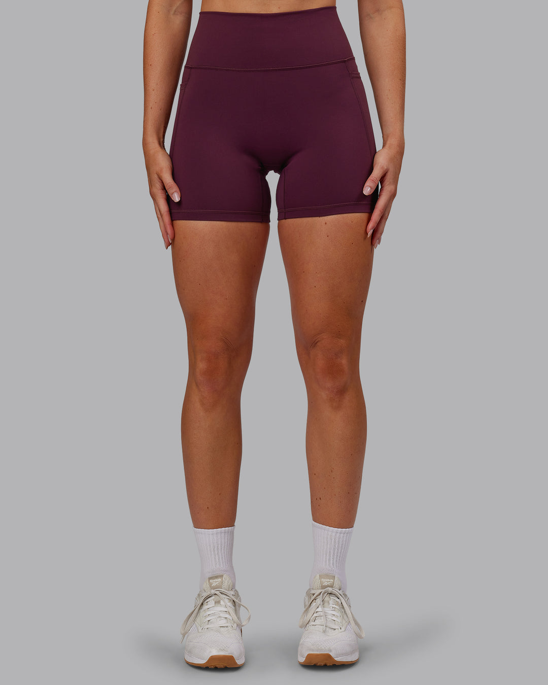 Woman wearing Fusion Ultra High-Rise 6&quot; Short Pockets - Cherry Lacquer | Model:Paris | Size:S
