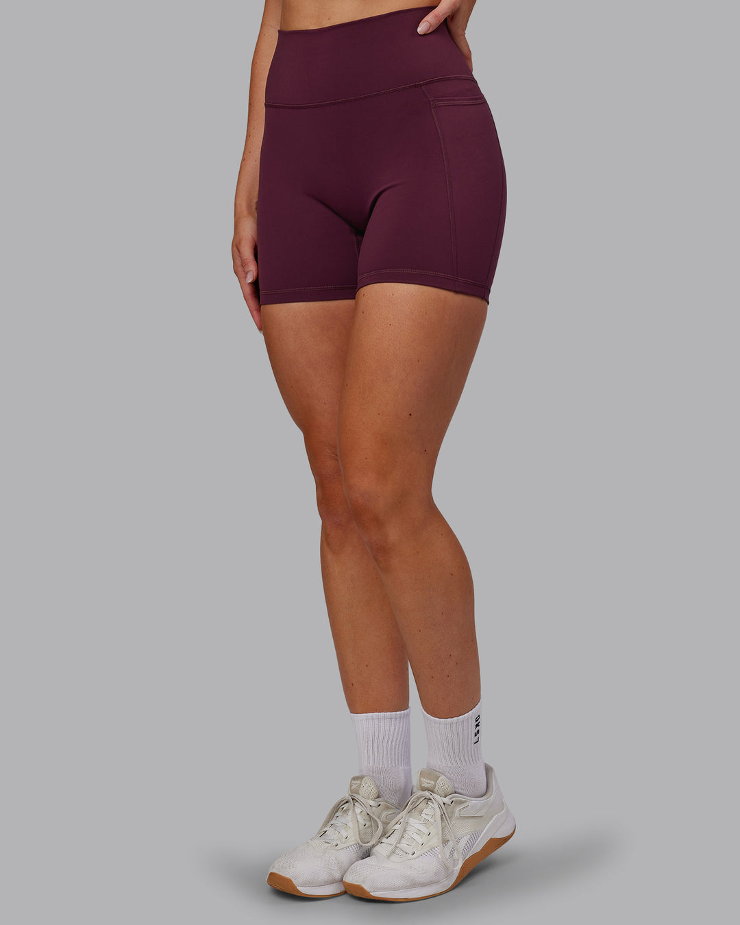 Woman wearing Fusion Ultra High-Rise 6&quot; Short Pockets - Cherry Lacquer | Model:Paris | Size:S