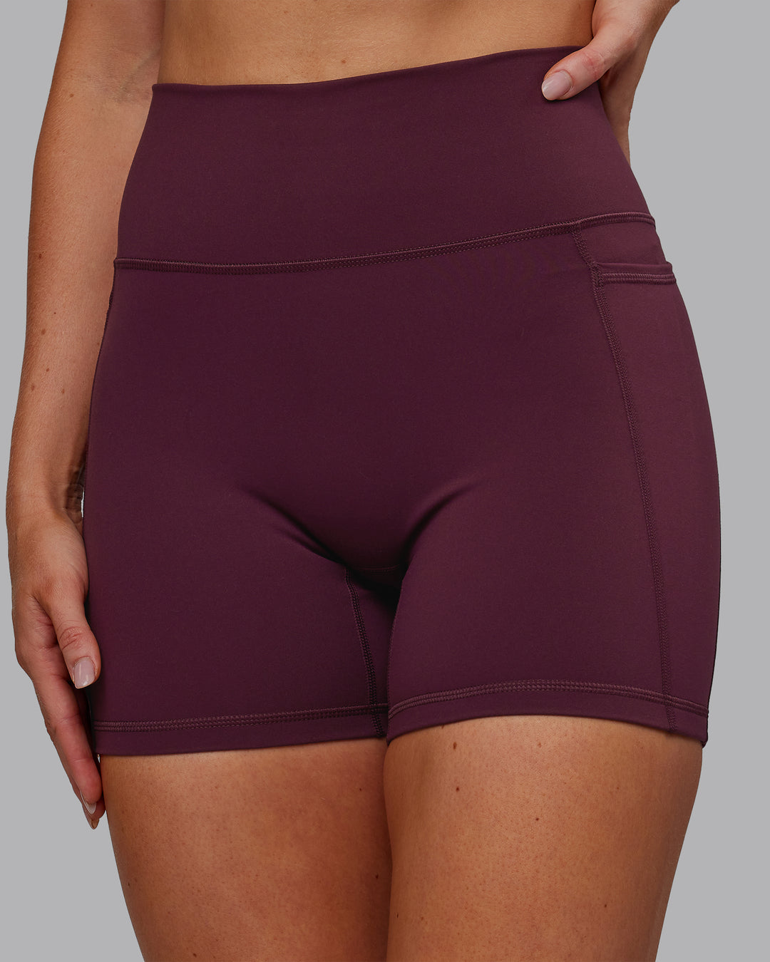 Woman wearing Fusion Ultra High-Rise 6&quot; Short Pockets - Cherry Lacquer | Model:Paris | Size:S