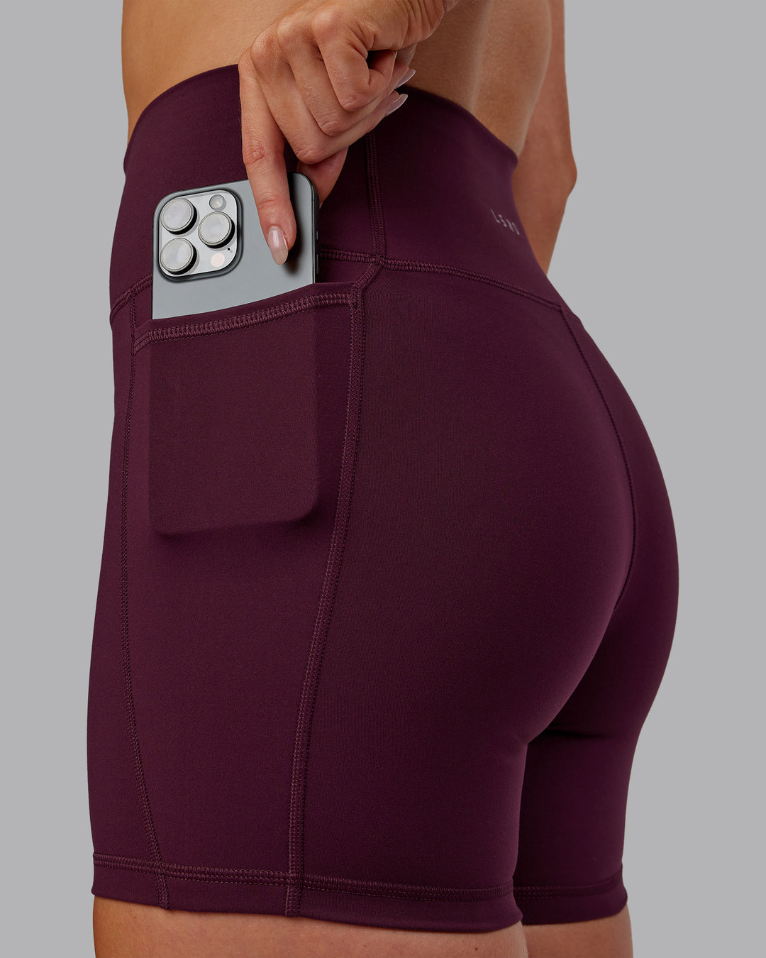 Woman wearing Fusion Ultra High-Rise 6&quot; Short Pockets - Cherry Lacquer | Model:Paris | Size:S