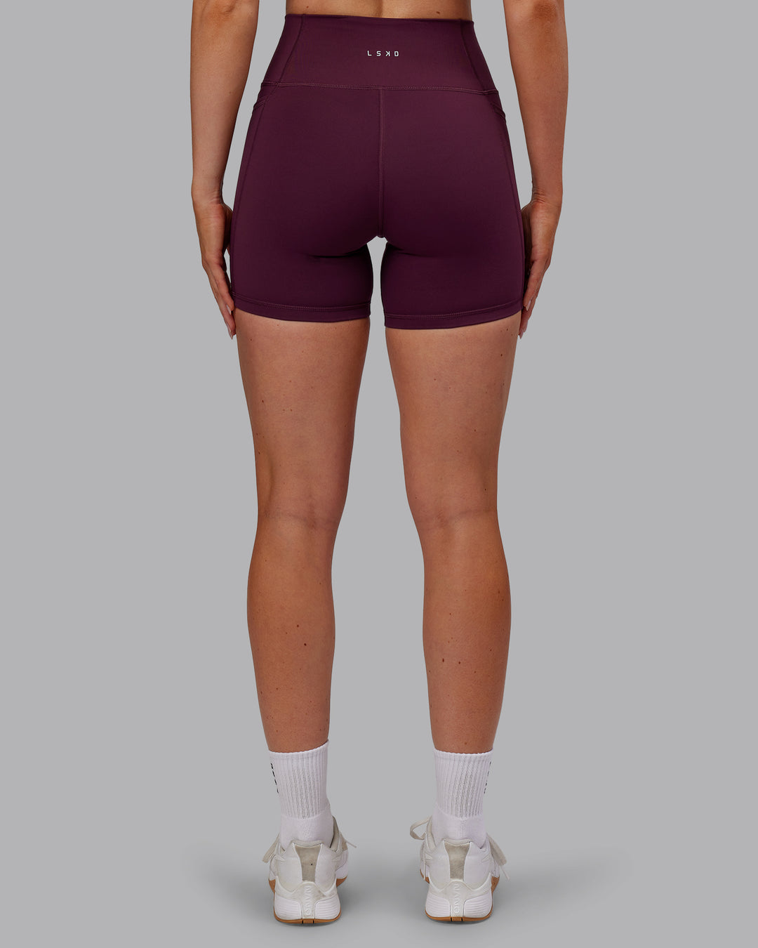 Woman wearing Fusion Ultra High-Rise 6&quot; Short Pockets - Cherry Lacquer | Model:Paris | Size:S