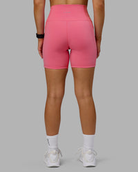 Woman wearing Fusion Ultra High-Rise 6" Short Pockets - Pink Lemonade | Model:Halle | Size:S