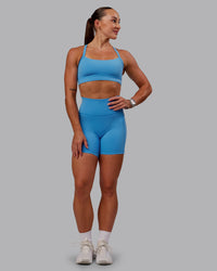 Woman wearing Fusion Ultra High-Rise 6" Short Pockets - Azure Blue | Model:Amber | Size:S