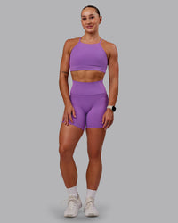 Woman wearing Fusion Ultra High-Rise 6" Short Pockets - Purple Fizz | Model:Amber | Size:S