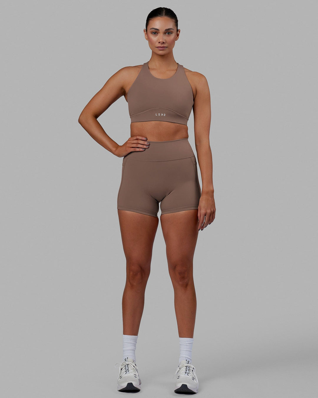 Woman wearing Fusion Sports Bra - Deep Taupe