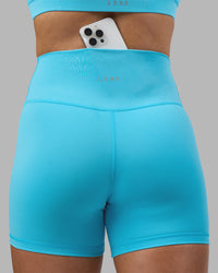 Woman wearing Fusion Ultra High-Rise 4" Short - Blue Atoll | Model:Georgia | Size:S