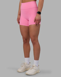 Woman wearing Fusion Ultra High-Rise 4" Short - Candy Pink | Set:true | Angle:side | Model:Keisha | Size:S