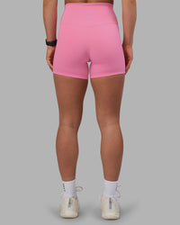 Woman wearing Fusion Ultra High-Rise 4" Short - Candy Pink | Set:true | Angle:back | Model:Keisha | Size:S