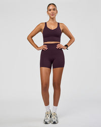 Woman wearing Fusion Ultra High-Rise 4" Short - Midnight Plum | Model:Rhiley | Size:S