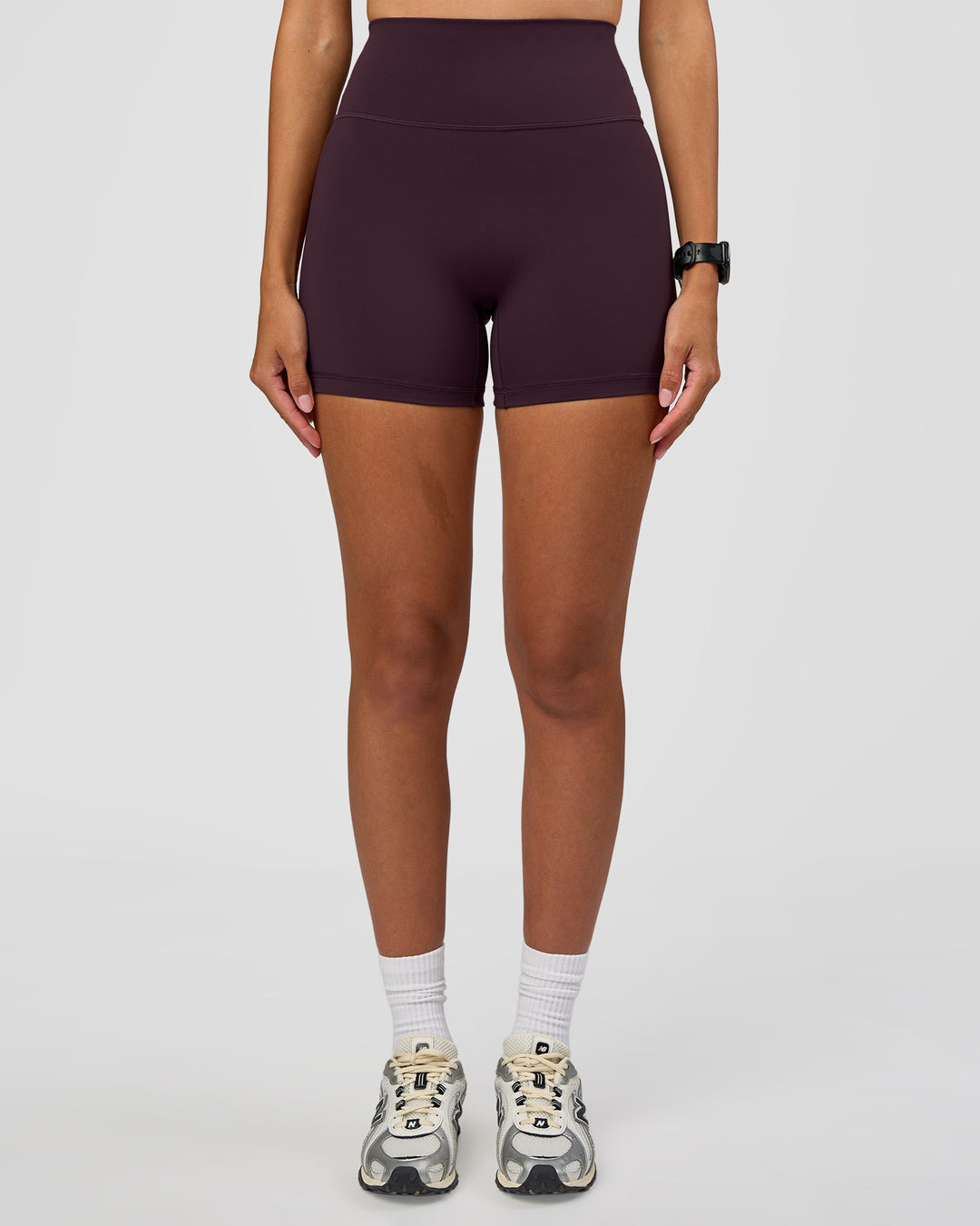 Woman wearing Fusion Ultra High-Rise 4" Short - Midnight Plum | Set:true | Angle:front | Model:Rhiley | Size:S