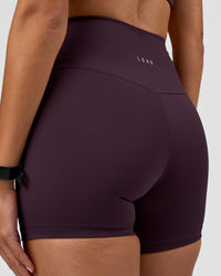 Woman wearing Fusion Ultra High-Rise 4" Short - Midnight Plum | Model:Rhiley | Size:S