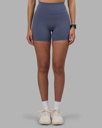 Woman wearing Fusion Ultra High-Rise 4" Short - Night Shadow | Set:true | Angle:front | Model:Rhiley | Size:S