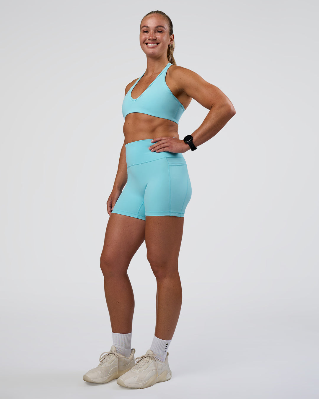 Woman wearing Fusion Ultra High-Rise 4&quot; Short Pockets - Baltic Sea | Model:Sav | Size:S