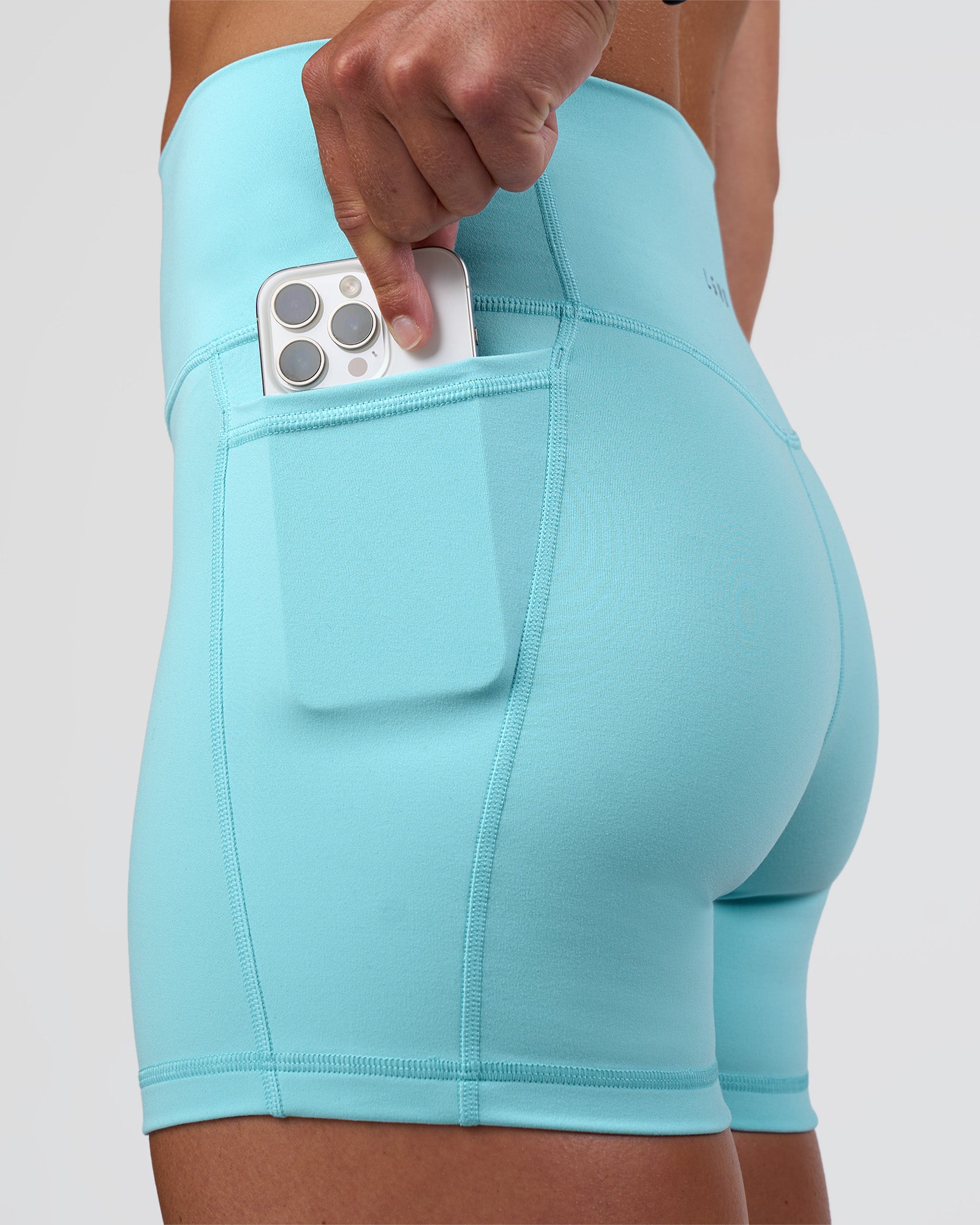 Woman wearing Fusion Ultra High-Rise 4" Short Pockets - Baltic Sea | Model:Sav | Size:S