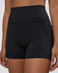 Woman wearing Fusion Ultra High-Rise 4" Short Pockets - Black | Model:Ruby | Size:S