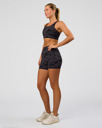 Woman wearing Fusion Ultra High-Rise 4" Short Pockets - Black Tie Dye | Model:Amity | Size:S