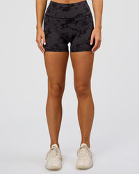 Woman wearing Fusion Ultra High-Rise 4" Short Pockets - Black Tie Dye | Set:true | Angle:front | Model:Amity | Size:S