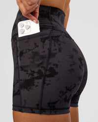 Woman wearing Fusion Ultra High-Rise 4" Short Pockets - Black Tie Dye | Set:true | Angle:closeup | Model:Amity | Size:S