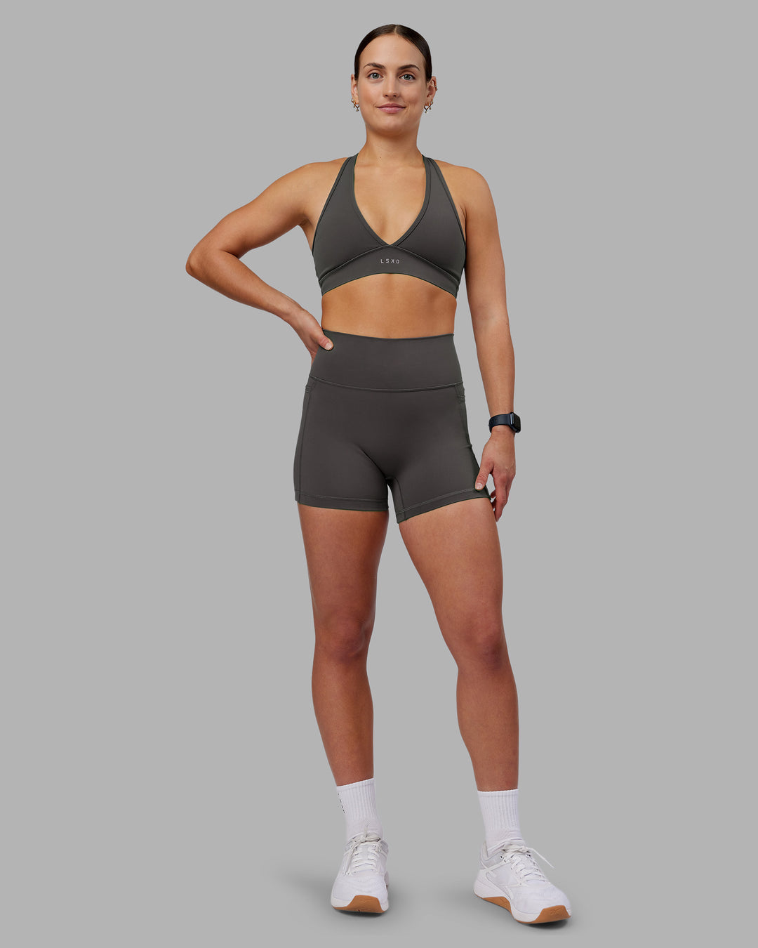 Woman wearing Fusion Ultra High-Rise 4&quot; Short Pockets - Dark Storm | Model:Keisha | Size:S