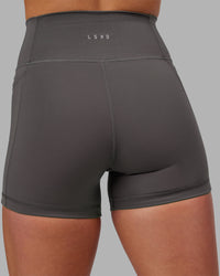 Woman wearing Fusion Ultra High-Rise 4" Short Pockets - Dark Storm | Model:Keisha | Size:S