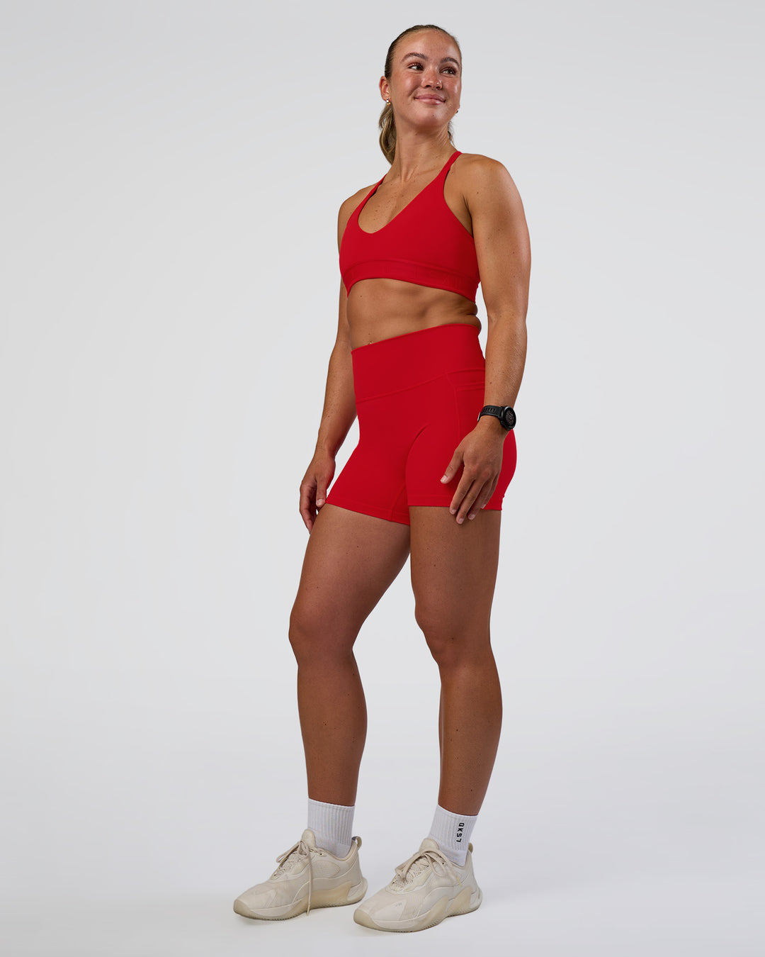 Woman wearing Fusion Ultra High-Rise 4&quot; Short Pockets - Flame | Model:Sav | Size:S