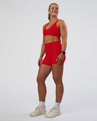Woman wearing Fusion Ultra High-Rise 4" Short Pockets - Flame | Model:Sav | Size:S