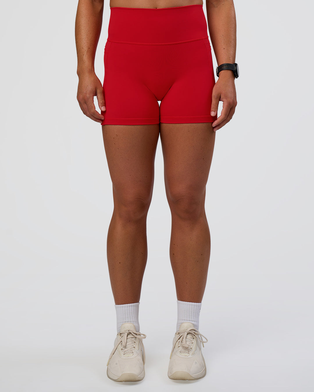 Woman wearing Fusion Ultra High-Rise 4&quot; Short Pockets - Flame | Model:Sav | Size:S