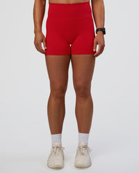 Woman wearing Fusion Ultra High-Rise 4" Short Pockets - Flame | Set:true | Angle:front | Model:Sav | Size:S