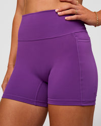 Woman wearing Fusion Ultra High-Rise 4" Short Pockets - Fresh Purple | Model:Emelia | Size:S