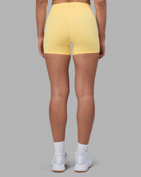 Woman wearing Fusion Ultra High-Rise 4" Short Pockets - Lemon | Model:Sophie | Size:S