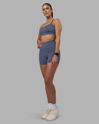 Woman wearing Fusion Ultra High-Rise 4" Short Pockets - Night Shadow | Model:Rhiley | Size:S