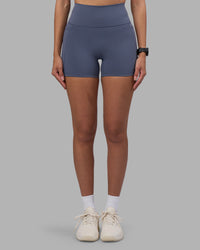 Woman wearing Fusion Ultra High-Rise 4" Short Pockets - Night Shadow | Set:true | Angle:front | Model:Rhiley | Size:S