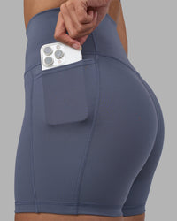 Woman wearing Fusion Ultra High-Rise 4" Short Pockets - Night Shadow | Set:true | Angle:closeup | Model:Rhiley | Size:S