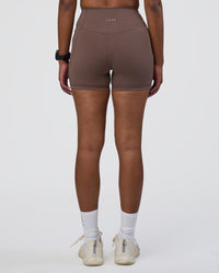 Woman wearing Fusion Ultra High-Rise 4" Short Pockets - Peppercorn | Set:true | Angle:back | Model:Rica | Size:S