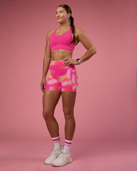 Woman wearing Fusion Ultra High-Rise 4" Short Pockets - Pink Glow Print | Model:Hannah | Size:S